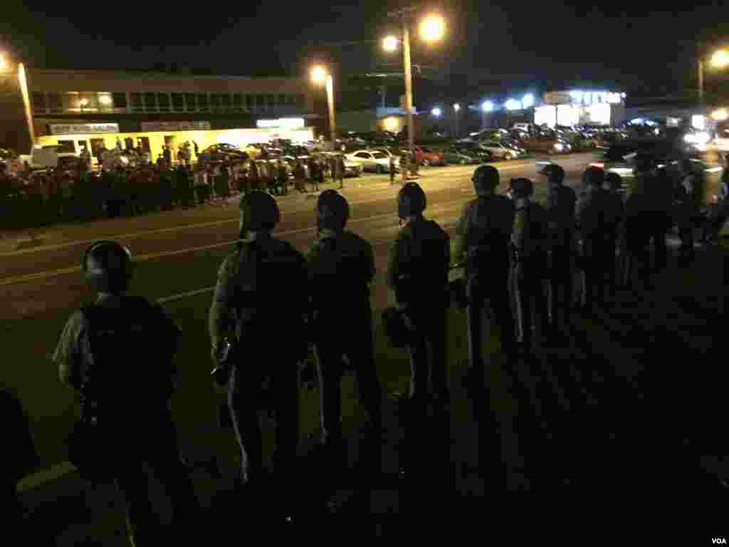 Police and protesters assembling on West Flourissant in Ferguson, August 10, 2015. (Kane Farabaugh/VOA News)