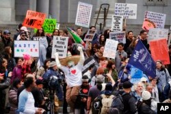 Protesters stand on the steps of Los Angeles City Hall, Feb. 20, 2017.