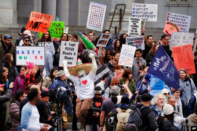 Protesters stand on the steps of Los Angeles City Hall, Feb. 20, 2017.