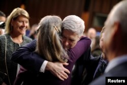 Supreme Court nominee Neil Gorsuch hugs family members during a break in his confirmation hearings before the Senate Judiciary Committee in Washington, March 22, 2017.
