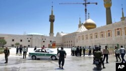 FILE - Police officers patrol the scene, around the shrine of late Iranian revolutionary founder Ayatollah Ruhollah Khomeini, after an attack by several Islamic State militants, in Tehran, Iran, June 7, 2017.