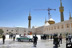 Police officers patrol the scene, around the shrine of late Iranian revolutionary founder Ayatollah Khomeini, after an attack by several perpetrators in Tehran, Iran, June 7, 2017.