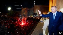 Turkish President Recep Tayyip Erdogan waves to supporters of his ruling Justice and Development Party (AKP) in Ankara, Turkey, June 25, 2018, having won Turkey's landmark election Sunday. 