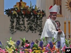 Juan Barros smiles as he leaves the altar after Mass was celebrated by Pope Francis on Lobito Beach in Iquique, Chile, Thursday, Jan. 18, 2018.