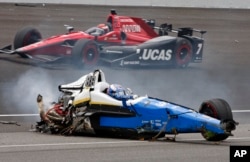 Scott Dixon, of New Zealand, sits in the remains of his car after going airborne in a crash during the running of the Indianapolis 500 auto race at Indianapolis Motor Speedway, May 28, 2017, in Indianapolis, Indiana.