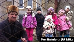 Mudasir Kafodar, a 55-year-old Crimean Tatar is pictured with his granddaughters.