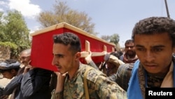 Houthi fighters carry the coffin of a comrade killed during recent fighting, during the first day of a cease-fire in Yemen's capital Sana'a, April 11, 2016. 