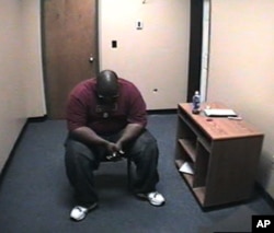 In 'Scenes of a Crime,' Adrian Thomas waits alone in the interrogation room of the Troy, New York police station on Sept. 21, 2008 after being accused of killing his child.