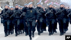Members of police forces of Republic of Srpska march during a parade marking 25th anniversary of Republic of Srpska in the Bosnian town of Banja Luka, Bosnia, Jan. 9, 2017.