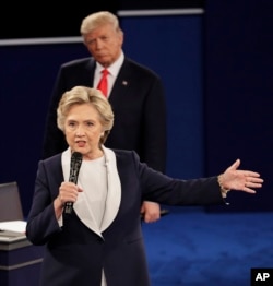 FILE - Republican presidential nominee Donald Trump listens to Democratic presidential nominee Hillary Clinton during the second presidential debate at Washington University in St. Louis, Oct. 9, 2016.
