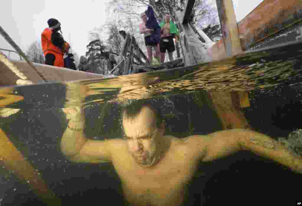 A Russian Orthodox believer submerges in the icy water during a traditional Epiphany celebration in St. Petersburg.