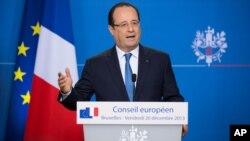 French President Francois Hollande addresses the media at the end of a two-day EU summit in Brussels, Dec. 20 2013.