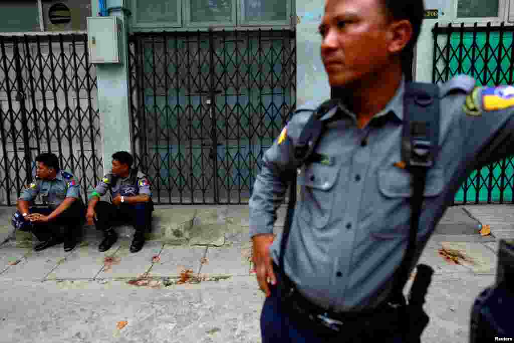 Police officers guard a Muslim residential area in Mandalay, Myanmar, July 3, 2014. 