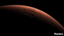 FILE - This computer-generated view depicts part of Mars at the boundary between darkness and daylight, with an area including Gale Crater beginning to catch morning light, in this handout image provided by NASA.