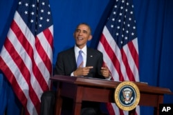 FILE - President Barack Obama smiles after signing an executive order in Washington, Oct. 17, 2014.