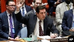 FILE - Russian Deputy U.N. Ambassador Vladimir Safronkov raises his hand to vote against a resolution at U.N. headquarters in New York, April 12, 2017.