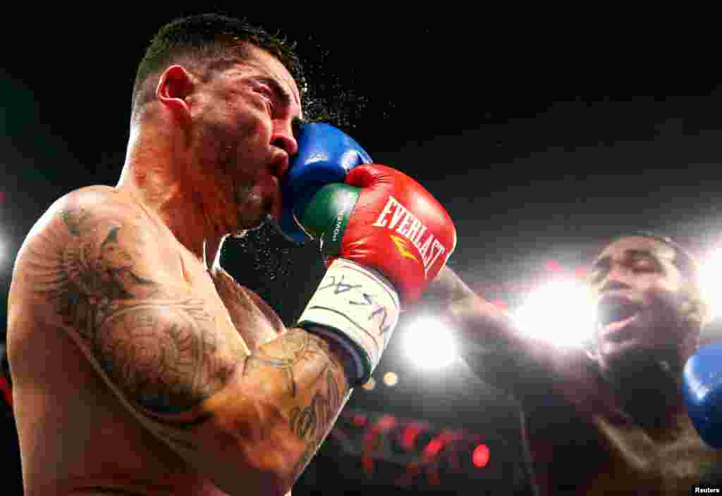 May 3, 2014; Las Vegas, NV, USA; Adrien Broner (blue gloves) lands a punch against Carlos Molina during their fight at MGM Grand in Las Vegas, Nevada, May 3, 2014. (Credit: Mark J. Rebilas - USA TODAY Sports)