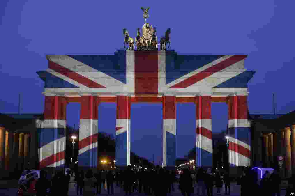 The Brandenburg Gate is illuminated in the colors of the British national flag in Berlin, Germany, to pay tribute to the victims of an attack in London.