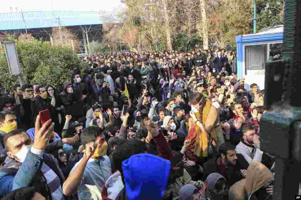 FILE - In this Saturday, Dec. 30, 2017 file photo taken by an individual not employed by the Associated Press and obtained by the AP outside Iran, university students attend a protest inside Tehran University while anti-riot Iranian police prevent them to