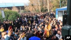 In this Saturday, Dec. 30, 2017 file photo taken by an individual not employed by the Associated Press and obtained by the AP outside Iran, university students attend a protest inside Tehran University while anti-riot Iranian police prevent them to