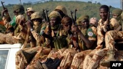 FILE - Chadian soldiers are seen sitting atop a pickup truck.