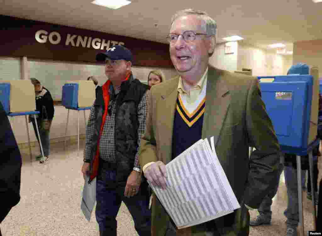 U.S. Senate Minority Leader Mitch McConnell waits to cast his vote after marking his ballot at Bellarmine University in Louisville, Kentucky, Nov. 4, 2014. 