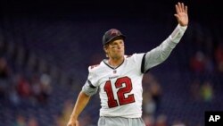 FILE - Tampa Bay Buccaneers quarterback Tom Brady waves to fans as he leaves the field after an NFL preseason football game against the Houston Texans, Aug. 28, 2021, in Houston.