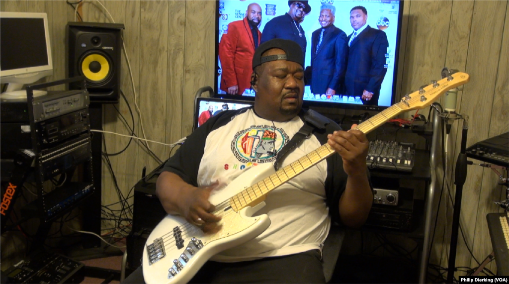 Big Tony Fisher demonstrating his skill on the bass guitar.