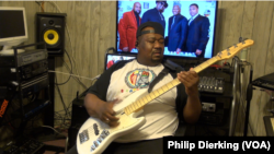 Big Tony Fisher demonstrating his skill on the bass guitar.