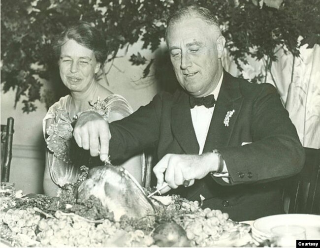First Lady Eleanor Roosevelt watches as President Franklin D. Roosevelt carves the traditional Thanksgiving turkey during supper at Warm Springs, Georgia, November 29, 1935. (Franklin D. Roosevelt Presidential Library and Museum/White House Historical Ass