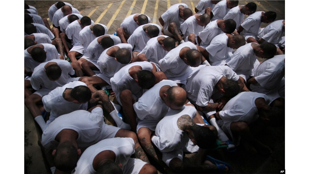 FILE - MS-13 gang members wait to be escorted upon arrival at the maximum-security jail in Zacatecoluca, El Salvador, Aug. 9, 2017.