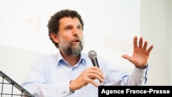 FILE - This undated photo made available on Oct. 15, 2021 and released by the Anadolu Culture Center shows Parisian-born Turkish philanthropist Osman Kavala speaking during an event in Istanbul.