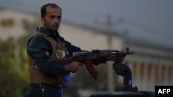 An Afghan security personnel keeps watch near the site of a suicide bomb attack near the Marshal Fahim military academy base in Kabul on October 21, 2017.