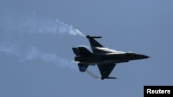 FILE - A Pakistani F-16 fighter performs during a ceremony marking Pakistan Defence Day in Islamabad, Pakistan.