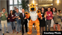 University of Missouri students stand with their school mascot, Truman the Tiger.