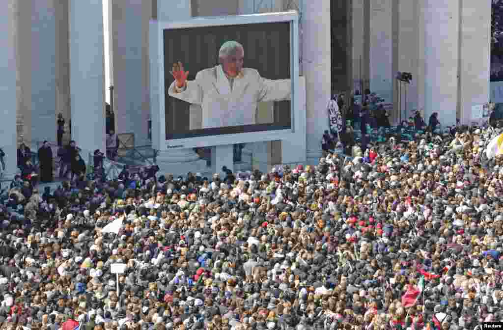 Pope Benedict appears on a giant screen in a packed St. Peter&#39;s Square at the Vatican during his last general audience, February 27, 2013. 