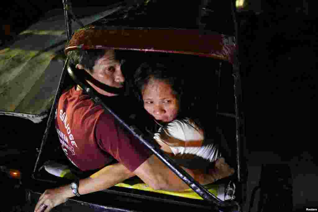 The mother of a man who was killed by two motorcycle-riding gunmen is comforted as police investigates in Manila, Philippines, Oct. 29, 2016.