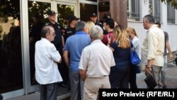 People mill around the High Court in Podgorica ahead of the trial of suspects charged with being involved in a coup attempt in 2016.