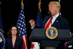 Incoming Central Intelligence Agency director Gina Haspel listens as President Donald Trump speaks during a swearing-in ceremony at CIA Headquarters, May 21, 2018, in Langley, Virginia.