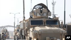 A team of 13 U.S. Marine Corps trainers assigned to the Iraqi Marine Training Team 03 depart the Iraqi city of Umm Qasr in this handout photograph taken on October 14, 2011 and obtained on October 21, 2011.