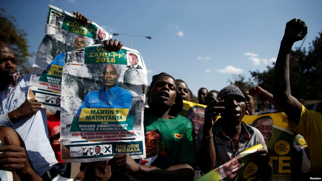 File - Supporters of the ruling ZANU-PF party of President Emmerson Mnangagwa celebrate following general elections in Harare, Zimbabwe, July 31, 2018.
