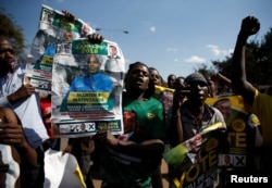 Supporters of the ruling ZANU-PF party of President Emmerson Mnangagwa celebrate following general elections in Harare, Zimbabwe, July 31, 2018.