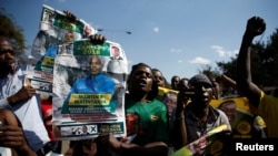 File - Supporters of the ruling ZANU-PF party of President Emmerson Mnangagwa celebrate following general elections in Harare, Zimbabwe, July 31, 2018. 