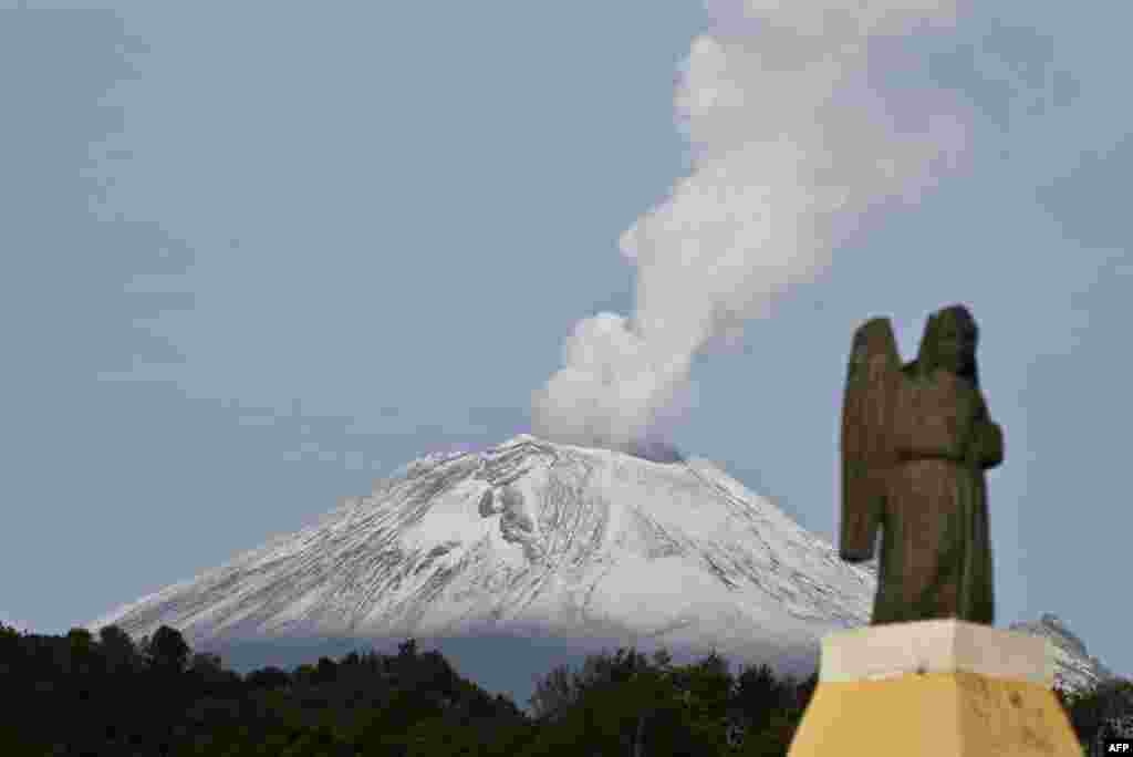 The Popocatepetl Volcano, Mexico&#39;s second highest peak just 55 km southeast of Mexico City, is seen from Santiago Xalitxintla, in Puebla - spewing a cloud of ash and smoke. 