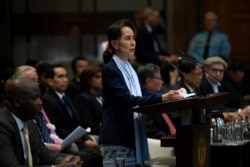 Myanmar's leader Aung San Suu Kyi addresses judges of the International Court of Justice for the second day of three days of hearings in The Hague, Netherlands, Wednesday, Dec. 11, 2019.