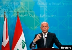 Britain's Foreign Secretary William Hague, who met with Iraq Prime Minister Nouri al-Maliki, speaks during a news conference in Baghdad, Iraq, June 26, 2014.