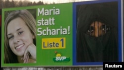 A poster of the Swiss People's Party (SVP) campaign for stringent immigration laws is placed beside a road in the town of Bremgarten, south of Zurich, Switzerland. The poster reads: 'Maria not Sharia !'. (file photo)