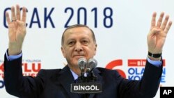 Turkey's President Recep Tayyip Erdogan gestures to supporters of his ruling Justice and Development Party at a rally in Bingol, Turkey, Jan. 13, 2018. Erdogan has said Turkey will oust Kurdish militants from Afrin, northern Syria, as the military shelled the area from across the border. Turkey considers the YPG a terror group and an extension of the Kurdish insurgency within its own borders.