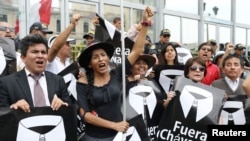 People hold placards reading "Chavarry out" referring to Peru Attorney General Pedro Chavarry, during a protest outside the Attorney General's Office in Lima, Peru, Jan. 8, 2019. 