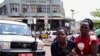 FILE - A woman reacts near the scene of a blast in Kampala, Uganda, Nov. 16, 2021. 